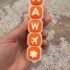 Personalized name keychain - Soft style, rounded silicone base with orange blocks and icon accents